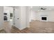 Bright hallway leading to the living room and kitchen featuring wood-look floors and neutral paint at 7141 Pitchfork Ln, Mint Hill, NC 28227