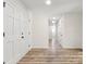 Hallway featuring wood look flooring and multiple access doors at 7141 Pitchfork Ln, Mint Hill, NC 28227