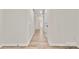 Bright hallway featuring hardwood floors, white walls, and doors leading to various rooms at 7141 Pitchfork Ln, Mint Hill, NC 28227