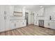 Kitchen features white cabinets, subway tile backsplash, stainless steel appliances and wood look flooring at 7141 Pitchfork Ln, Mint Hill, NC 28227