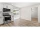 Modern kitchen with stainless steel appliances and adjacent dining area with sliding glass door at 7141 Pitchfork Ln, Mint Hill, NC 28227