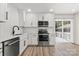 Bright kitchen showcases stainless steel appliances, white cabinets and a stylish faucet at 7141 Pitchfork Ln, Mint Hill, NC 28227