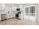 Open kitchen showcases stainless steel appliances, white cabinets, and access to the outdoor patio at 7141 Pitchfork Ln, Mint Hill, NC 28227