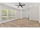 Bright living space featuring hard surface floors, neutral paint, and white blinds for natural light at 7141 Pitchfork Ln, Mint Hill, NC 28227
