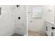 The tiled shower features black hardware and a decorative tile accent at 7141 Pitchfork Ln, Mint Hill, NC 28227