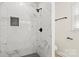 The tiled shower features black hardware and a decorative tile accent at 7141 Pitchfork Ln, Mint Hill, NC 28227