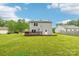 Back exterior with expansive lawn, deck, siding, and solar panels for modern living at 759 Victory Gallop Ave, Clover, SC 29710