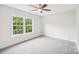 Bright bedroom with a ceiling fan, plush carpet, and a large window offering a pleasant view at 759 Victory Gallop Ave, Clover, SC 29710