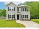 Charming two-story home with gray siding, black shutters, lush lawn, and solar panels at 759 Victory Gallop Ave, Clover, SC 29710