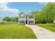 Two-story home with gray siding and black shutters with a well-manicured front lawn at 759 Victory Gallop Ave, Clover, SC 29710