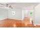 Open-concept living area featuring hardwood floors, white walls, and a ceiling fan at 759 Victory Gallop Ave, Clover, SC 29710