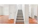 Carpeted staircase with white banister connecting multiple levels in a well-lit home at 759 Victory Gallop Ave, Clover, SC 29710