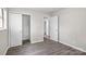 Bedroom featuring laminate floors, light gray walls, closet, and open doorway to additional bedrooms and bathroom at 816 Echo Glen Rd, Charlotte, NC 28213