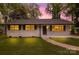 Charming single-story home with white brick, dark shutters, and a lush green lawn at 816 Echo Glen Rd, Charlotte, NC 28213