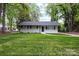 The house has a green lawn and mature trees at 816 Echo Glen Rd, Charlotte, NC 28213