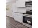 The kitchen features stainless steel appliances, modern white cabinetry, and a bright window at 816 Echo Glen Rd, Charlotte, NC 28213