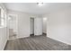 Main bedroom boasts gray laminate floors, light gray walls, ample closet space, and en-suite bathroom at 816 Echo Glen Rd, Charlotte, NC 28213