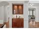 Stylish bar area with glass-front cabinets and dark countertops adjacent to the living space at 9217 Rock Water Ct, Waxhaw, NC 28173