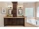 Luxurious bathroom featuring dual vanities, a soaking tub, and natural stone finishes at 9217 Rock Water Ct, Waxhaw, NC 28173