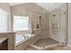 Lavish bathroom with a soaking tub, glass shower, and luxurious finishes at 9217 Rock Water Ct, Waxhaw, NC 28173