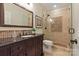 Elegant bathroom featuring a dark wood vanity, mosaic tile accents, and a walk-in shower with glass enclosure at 9217 Rock Water Ct, Waxhaw, NC 28173