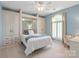 Bedroom featuring built-in storage, blue walls, carpet, and a bright window at 9217 Rock Water Ct, Waxhaw, NC 28173
