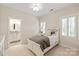 Bright bedroom featuring neutral walls, carpet, shuttered windows, and an ensuite bathroom at 9217 Rock Water Ct, Waxhaw, NC 28173