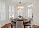 Elegant dining area featuring shuttered windows, hardwood floors, and a chandelier, offering a cozy and stylish setting at 9217 Rock Water Ct, Waxhaw, NC 28173