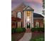 Stately red brick home featuring a grand two-story entrance with white pillars and manicured landscaping at 9217 Rock Water Ct, Waxhaw, NC 28173