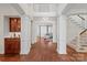 Expansive foyer with hardwood floors, white columns, a bar area, and an open staircase at 9217 Rock Water Ct, Waxhaw, NC 28173