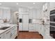 Spacious white kitchen with modern appliances, ample cabinetry, and hardwood floors, perfect for cooking and entertaining at 9217 Rock Water Ct, Waxhaw, NC 28173