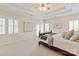 Bright main bedroom with a trey ceiling, a large bed, and access to a screened porch at 9217 Rock Water Ct, Waxhaw, NC 28173