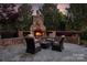Inviting outdoor living space featuring a stone fireplace and comfortable seating area at 9217 Rock Water Ct, Waxhaw, NC 28173