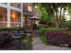 Backyard patio featuring a dining set, grill, and manicured landscaping with a fountain at 9217 Rock Water Ct, Waxhaw, NC 28173