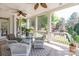 Charming screened-in porch featuring comfortable seating, ceiling fans, and serene views of the lush, landscaped backyard at 9217 Rock Water Ct, Waxhaw, NC 28173