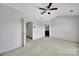 Open bedroom featuring a fan and entry to the on-suite bathroom at 9862 Walkers Glen Nw Dr, Concord, NC 28027
