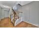 Spacious hallway with hardwood floors and stairs leading to the upper level at 9862 Walkers Glen Nw Dr, Concord, NC 28027