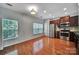 Bright eat in kitchen with wood floors, stainless steel appliances, with cherry wood cabinets at 9862 Walkers Glen Nw Dr, Concord, NC 28027