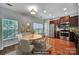 Eat in kitchen with stainless steel appliances, wooden cabinets, and a wood floor with a view of the windows at 9862 Walkers Glen Nw Dr, Concord, NC 28027