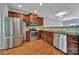Kitchen features stainless steel appliances, tile backsplash, and cherry wood cabinets at 9862 Walkers Glen Nw Dr, Concord, NC 28027