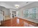 First floor laundry room with stainless steel appliances and wood floor at 9862 Walkers Glen Nw Dr, Concord, NC 28027