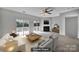 A staged living room featuring stylish furniture, a fireplace, and sliding doors leading to a balcony at 9862 Walkers Glen Nw Dr, Concord, NC 28027