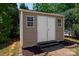 Backyard shed features double doors, two windows, and three wooden steps at 1004 Toquima Trl, Monroe, NC 28110