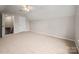 Spacious bedroom with plush carpeting and a closet; stairway to a bonus room or attic at 1004 Toquima Trl, Monroe, NC 28110