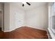 Comfortable bedroom featuring hardwood floors, a ceiling fan, closet, and a bright window at 1004 Toquima Trl, Monroe, NC 28110