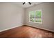 Comfortable bedroom with hardwood floors, a ceiling fan, and a large window for natural light at 1004 Toquima Trl, Monroe, NC 28110
