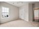 Cozy bedroom with soft carpeting, a ceiling fan, and a closet with paneled doors at 1004 Toquima Trl, Monroe, NC 28110