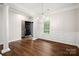 Spacious dining room showcases hardwood floors, modern chandelier, wainscoting and inviting entry at 1004 Toquima Trl, Monroe, NC 28110