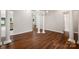 Dining room with wood floors, white columns, modern chandelier, and grey walls at 1004 Toquima Trl, Monroe, NC 28110