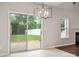 Dining room with sliding glass door, tile floor, and modern chandelier at 1004 Toquima Trl, Monroe, NC 28110